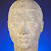 Thumbnail sculpture of a female head.